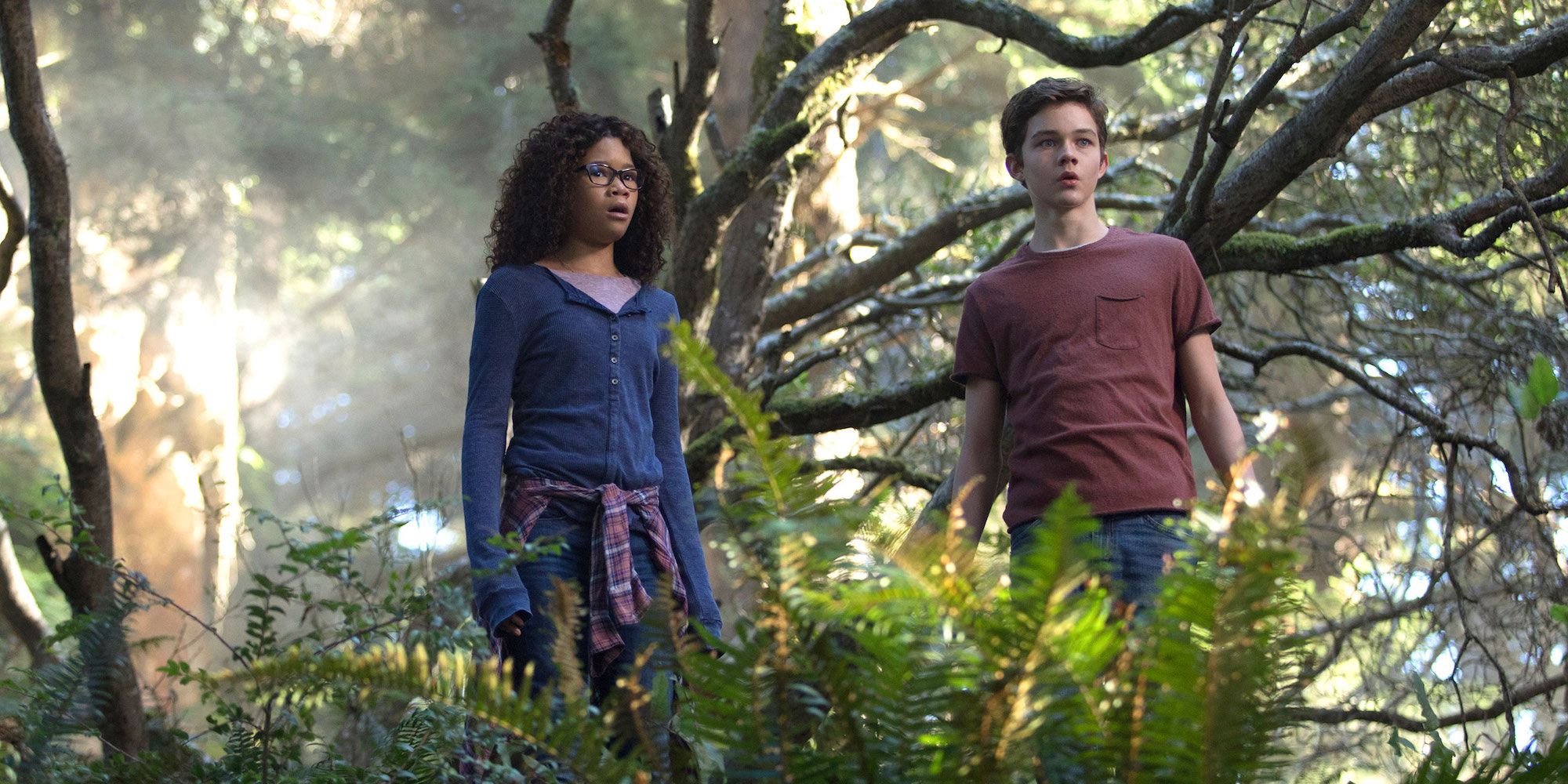 Storm Reid and Levi Miller in the forest in A Wrinkle in Time