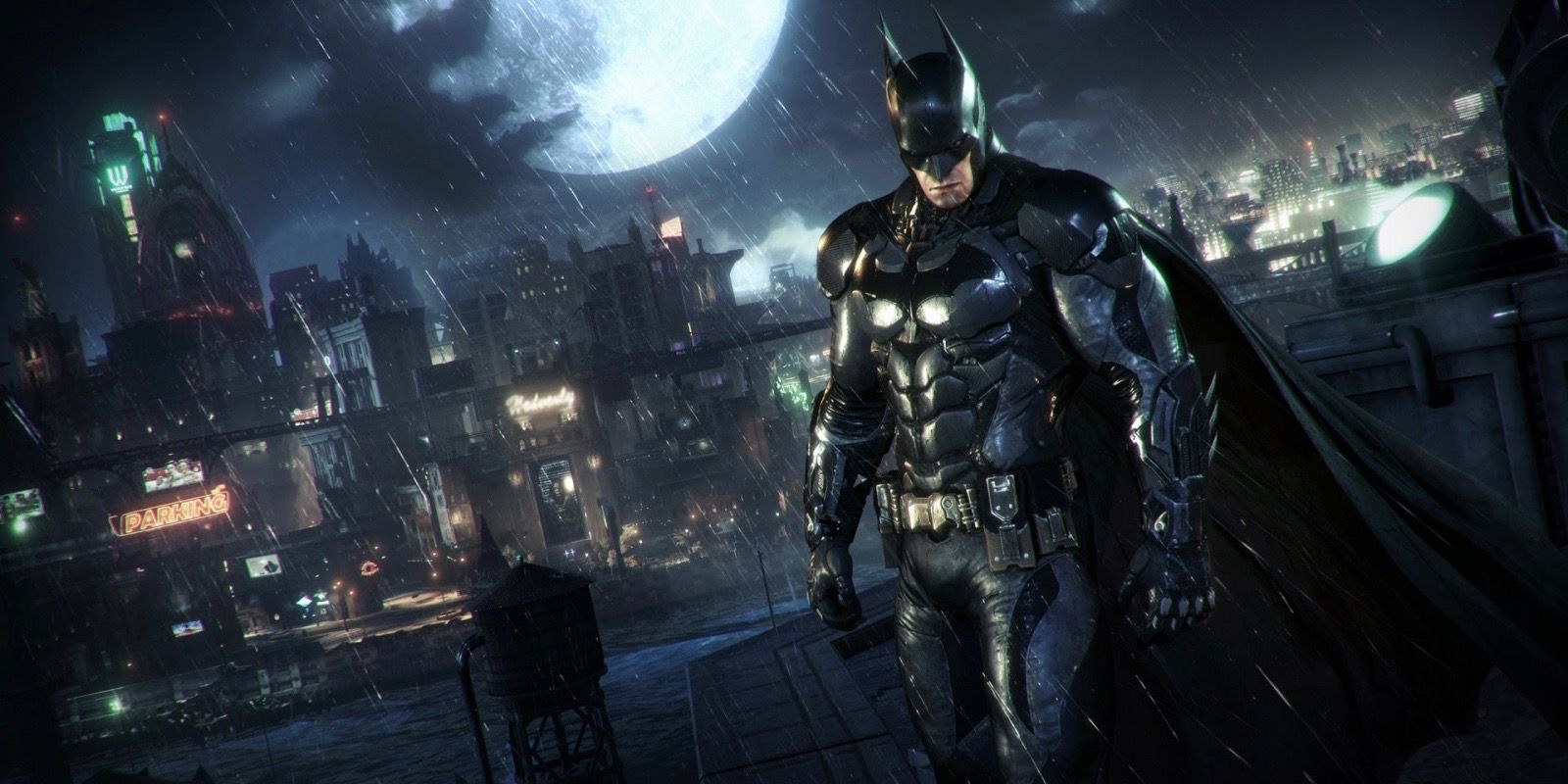 Batman standing atop a building at night with Gotham's cityscape behind him