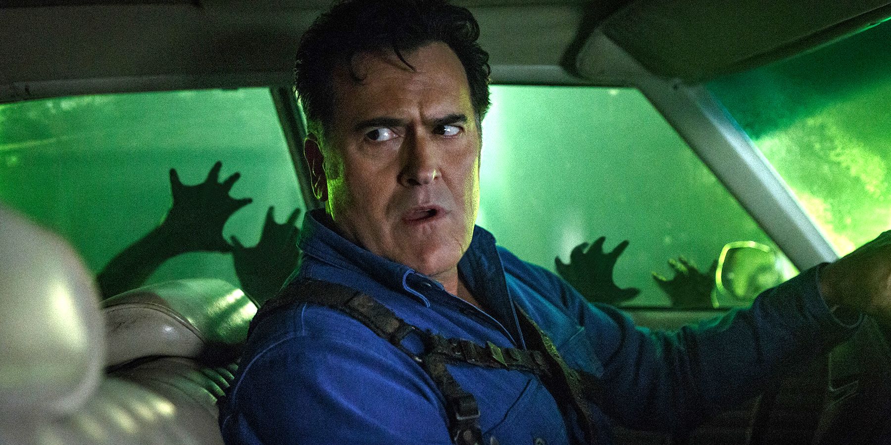 Bruce Campbell trapped in a car and surrounded by Deadites in Ash vs. Evil Dead Season 3