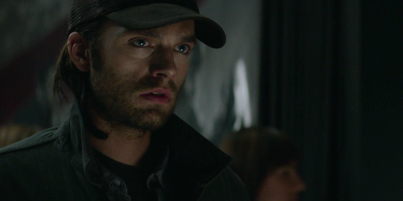Sebastian Stan as Bucky Barnes in Captain America The Winter Soldier, walking through a museum.