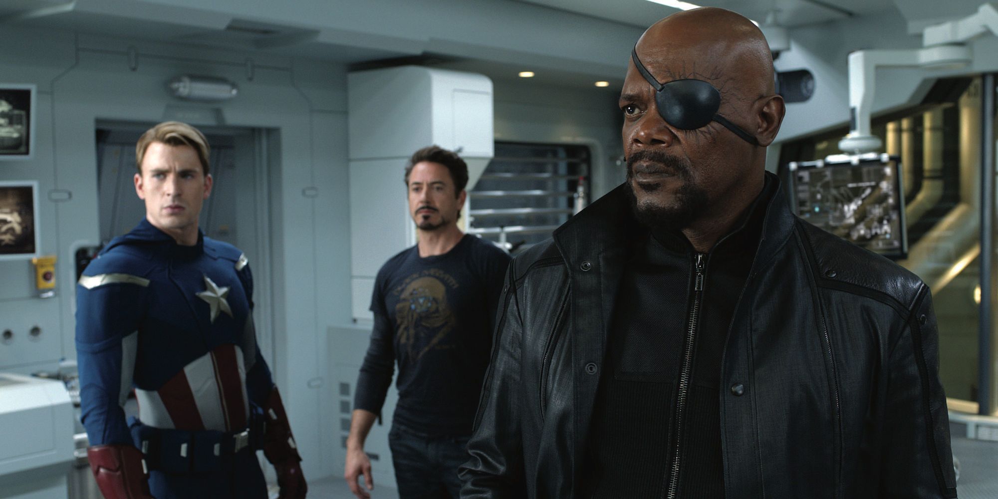 Nick Fury, Captain America, and Iron Man standing together in Tony's base in The Avengers