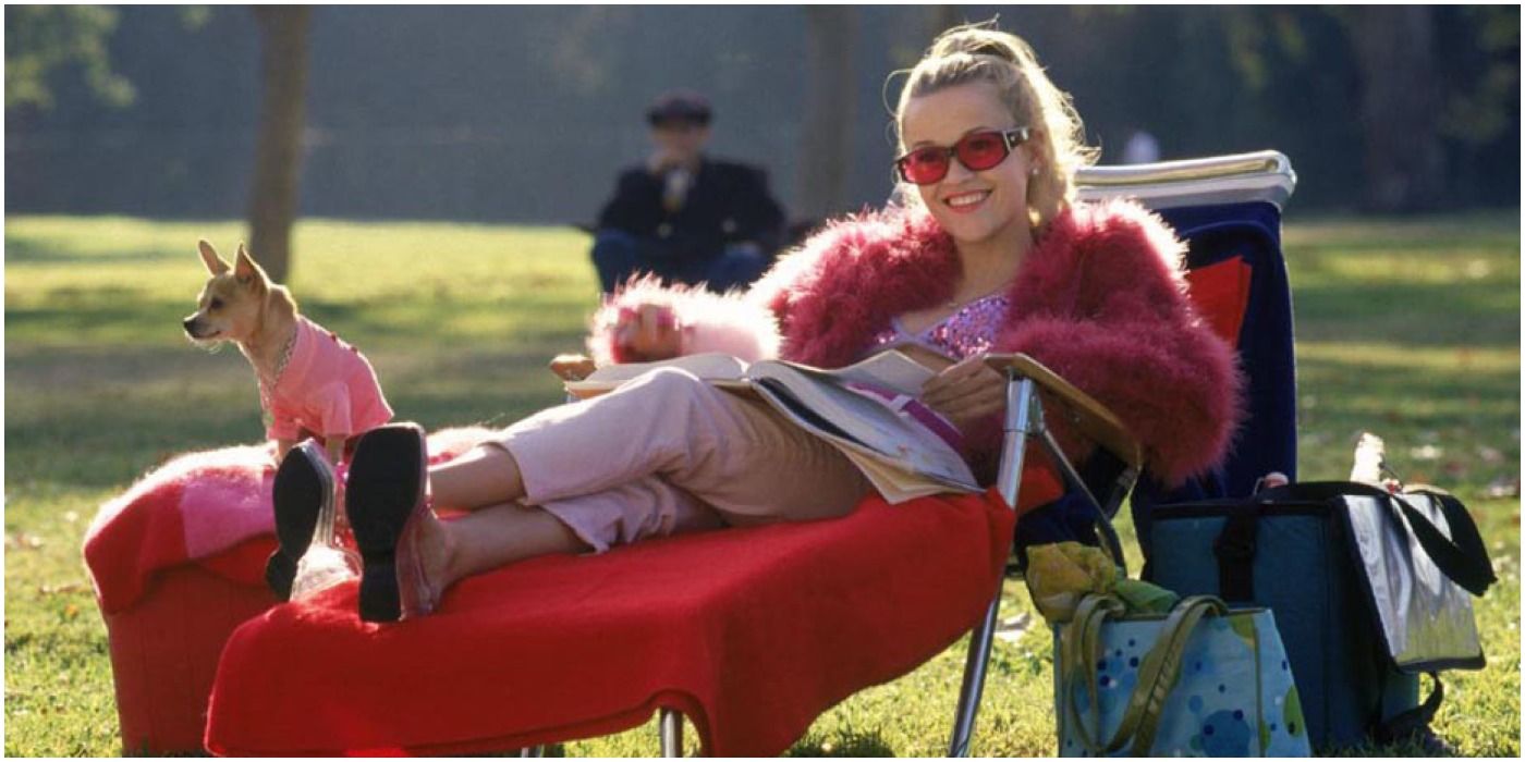 Reese Witherspoon reclining with her dog as Elle Woods in Legally Blonde