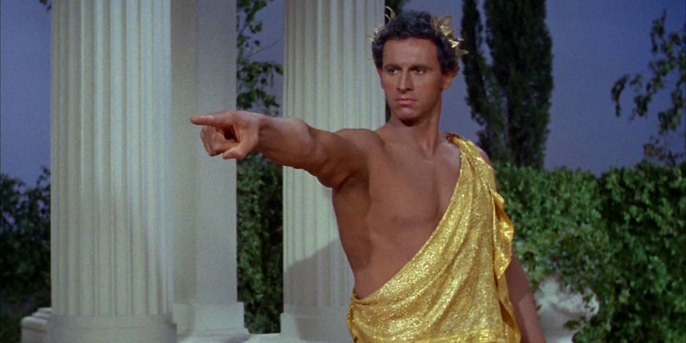 Michael Forest as Apollo pointing to the left of the screen on Star Trek