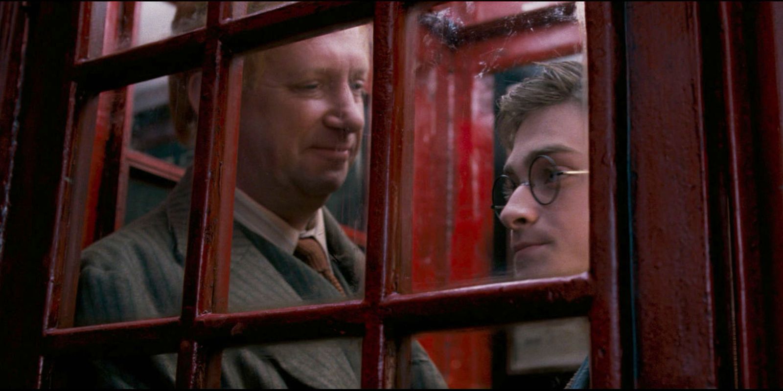 Harry and Mr. Weasley in the Ministry of Magic telephone booth.
