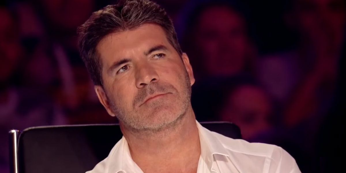 Simon-Cowell of Americas Got Talent looking cynically at someone on stage.