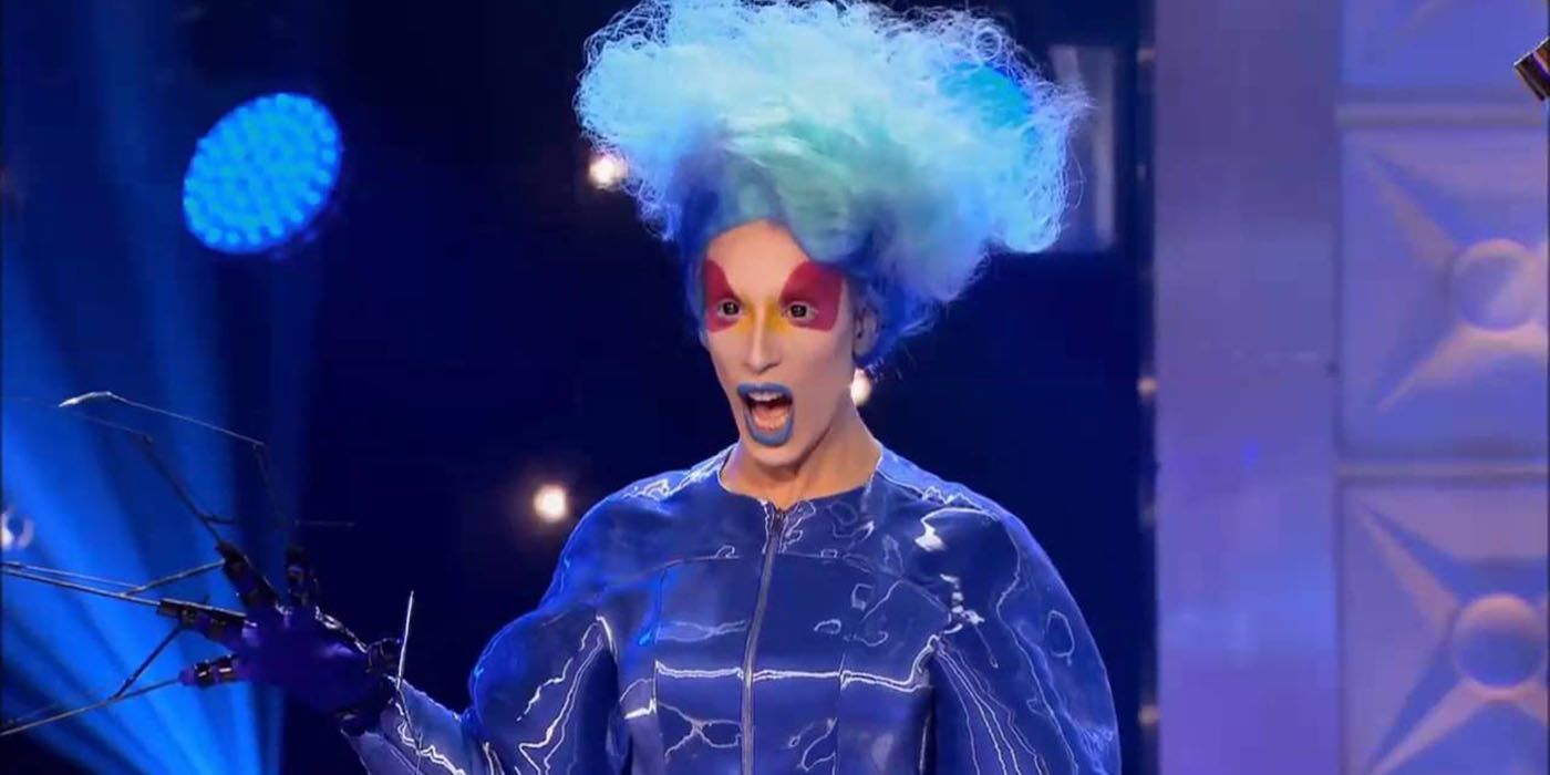 Alaska appears in a blue wig with bright red eye makeup from RuPaul's Drag Race 