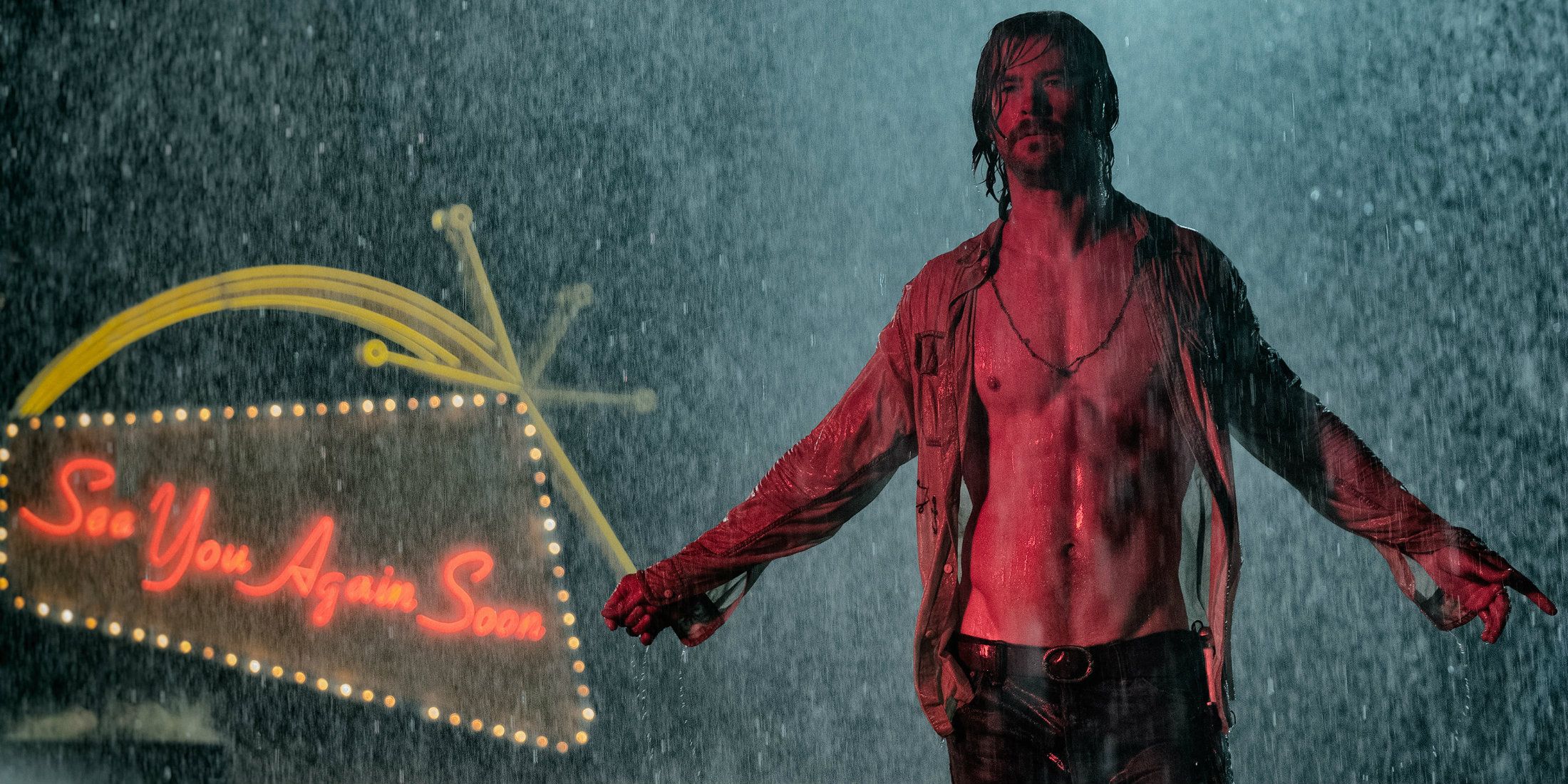 Billy Lee spreading his arms under the rain in Bad Times at the El Royale