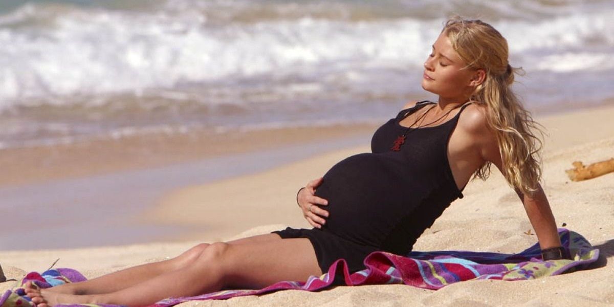 Claire is sitting on the beach while pregnant on Lost