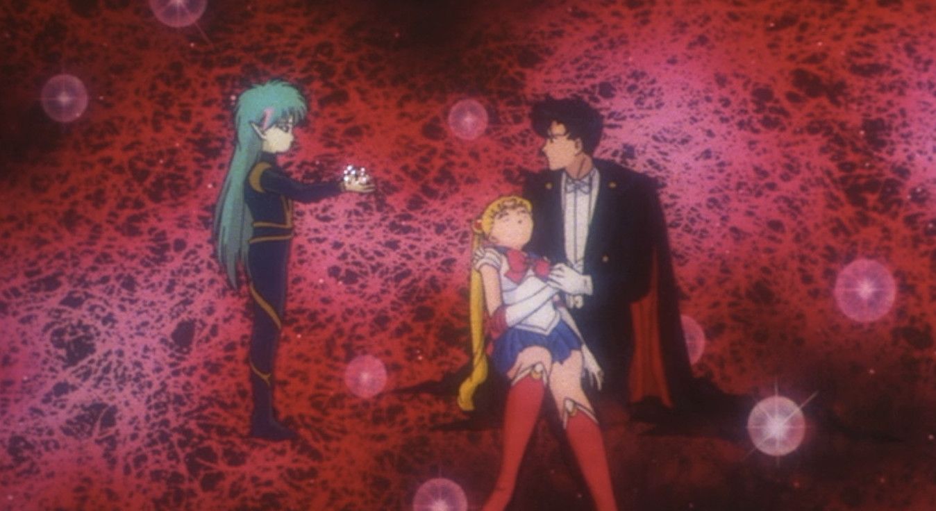 Fiore stands over Sailor Moon and Tuxedo Mask In Sailor Moon R