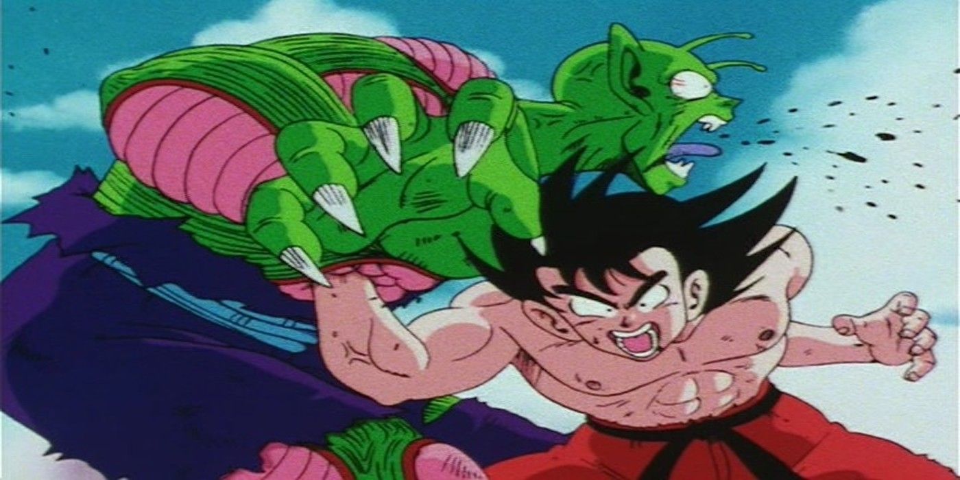 Goku yells as he punches an incredibly pained Piccolo in the stomach.