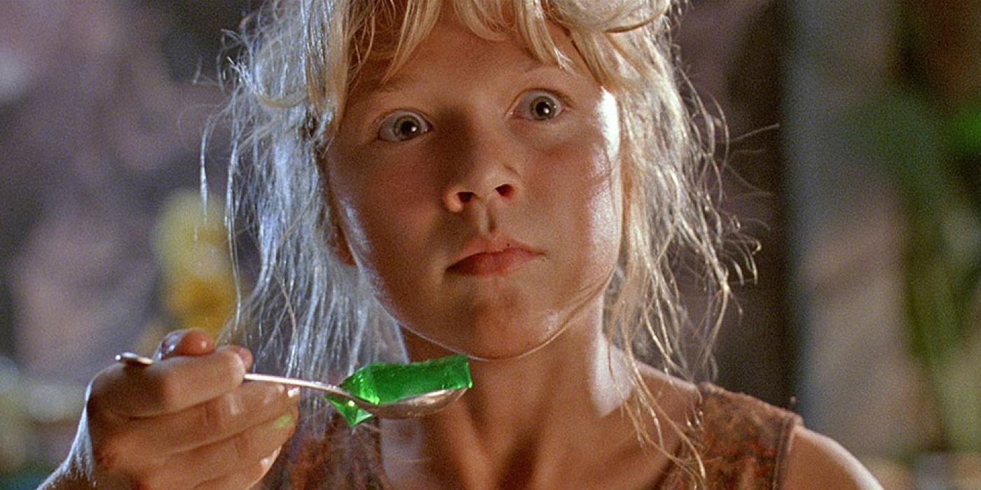 Lex looks terrified while holding up a spoonful of jello in Jurassic Park.