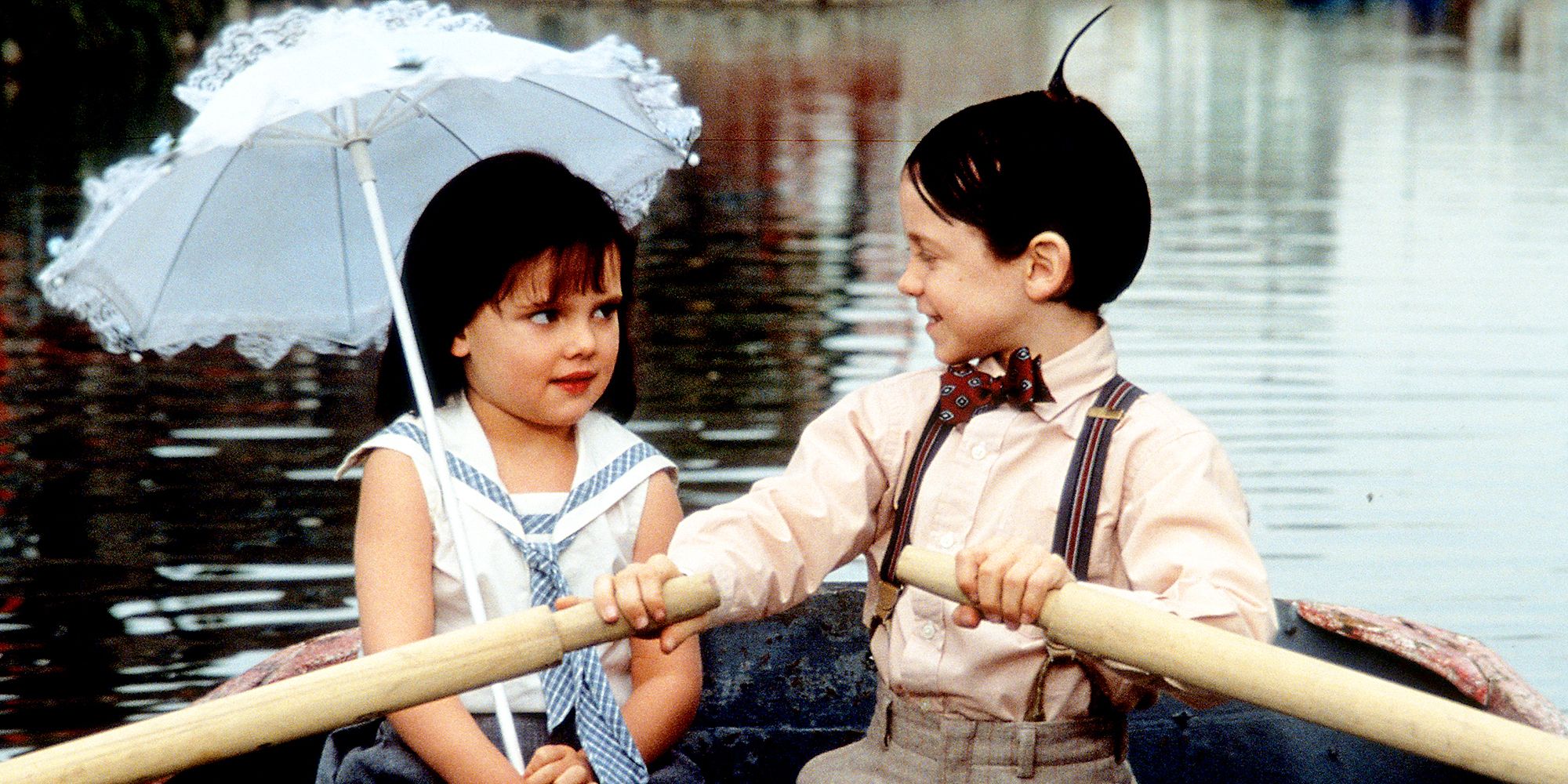 Sparky and Darla sit in a row boat in The Little Rascals