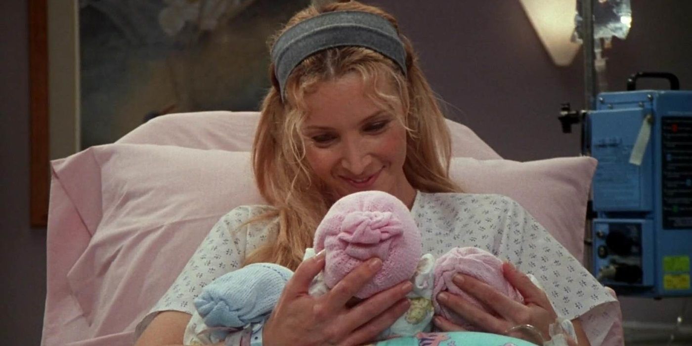 Phoebe holds the triplets in a hospital bed