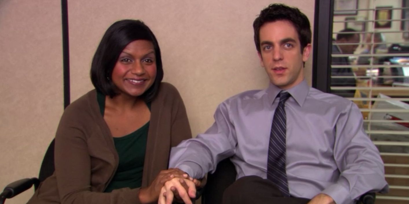 Ryan and Kelly from The Office holding hands.