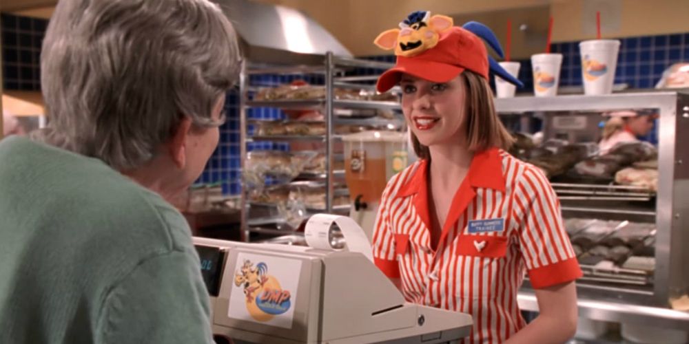 Buffy working her shift at the Doublemeat Palace, wearing a uniform and a fake smile.
