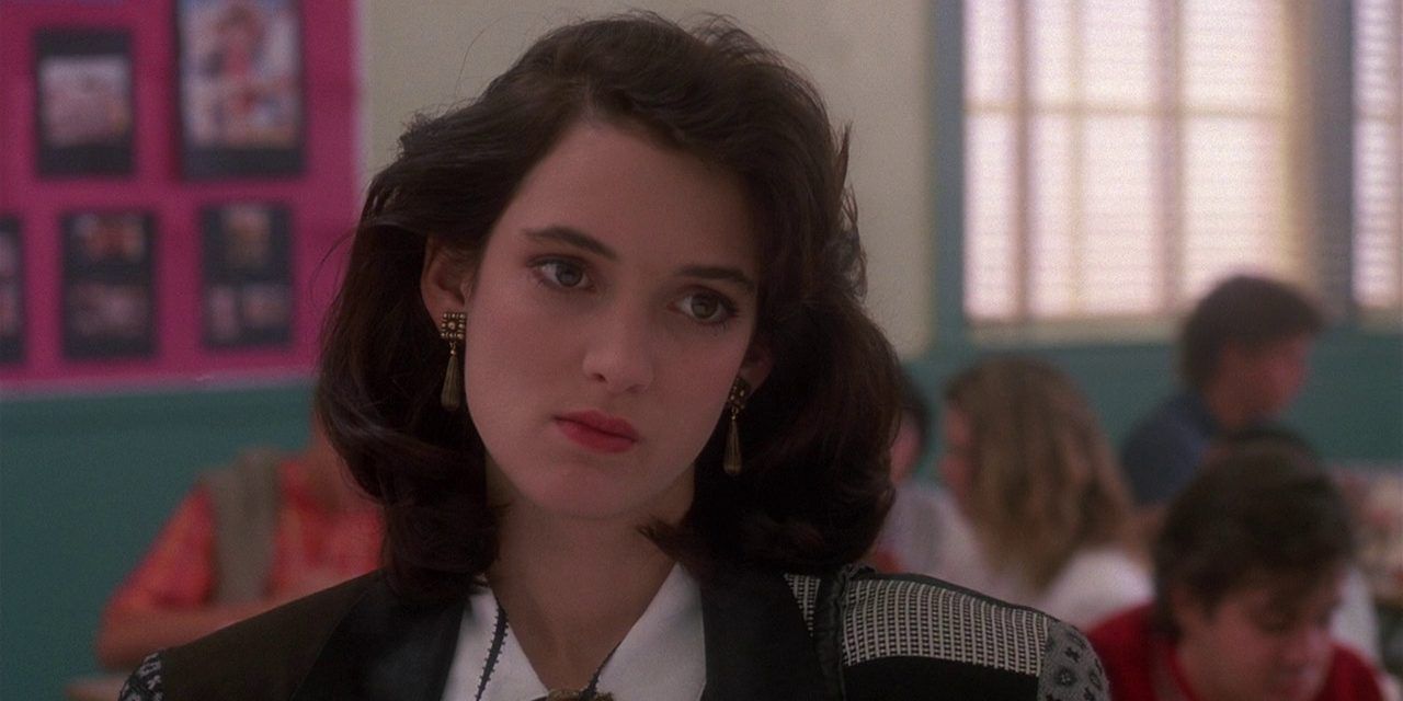 Winona Ryder as Veronica Sawyer standing in classroom in Heathers movie