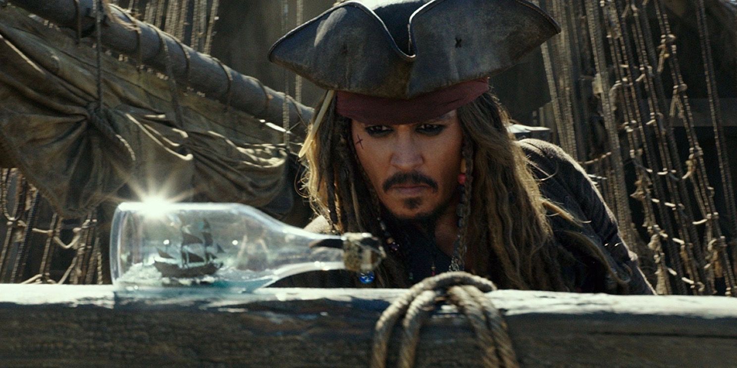 Jack Sparrow looks at a bottle in a ship in The Pirates of the Caribbean: Dead Men Tell No Tales