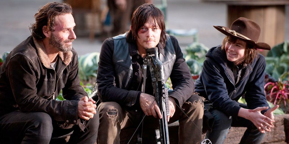 Rick, Carl, and Daryl sitting together on The Walking Dead.