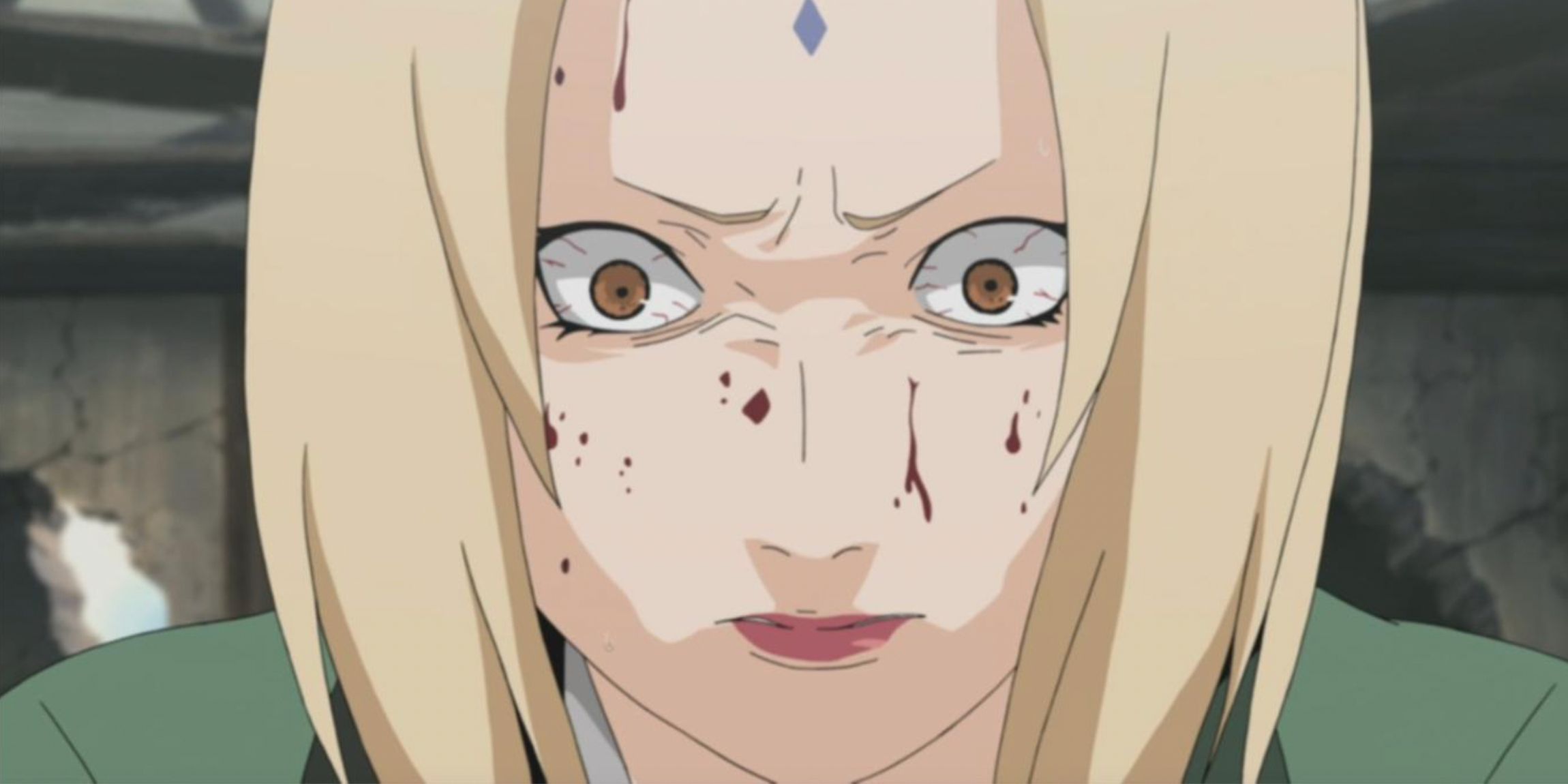 A closeup up of a scared Tsunade with blood on her face in Naruto