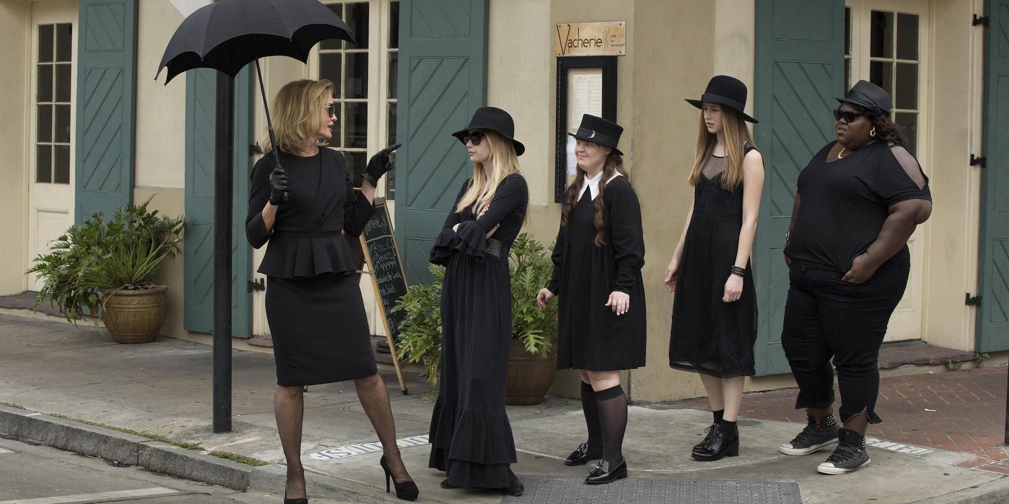 Cordelia and the girls from the coven walking down the street in American Horror Story: Coven.