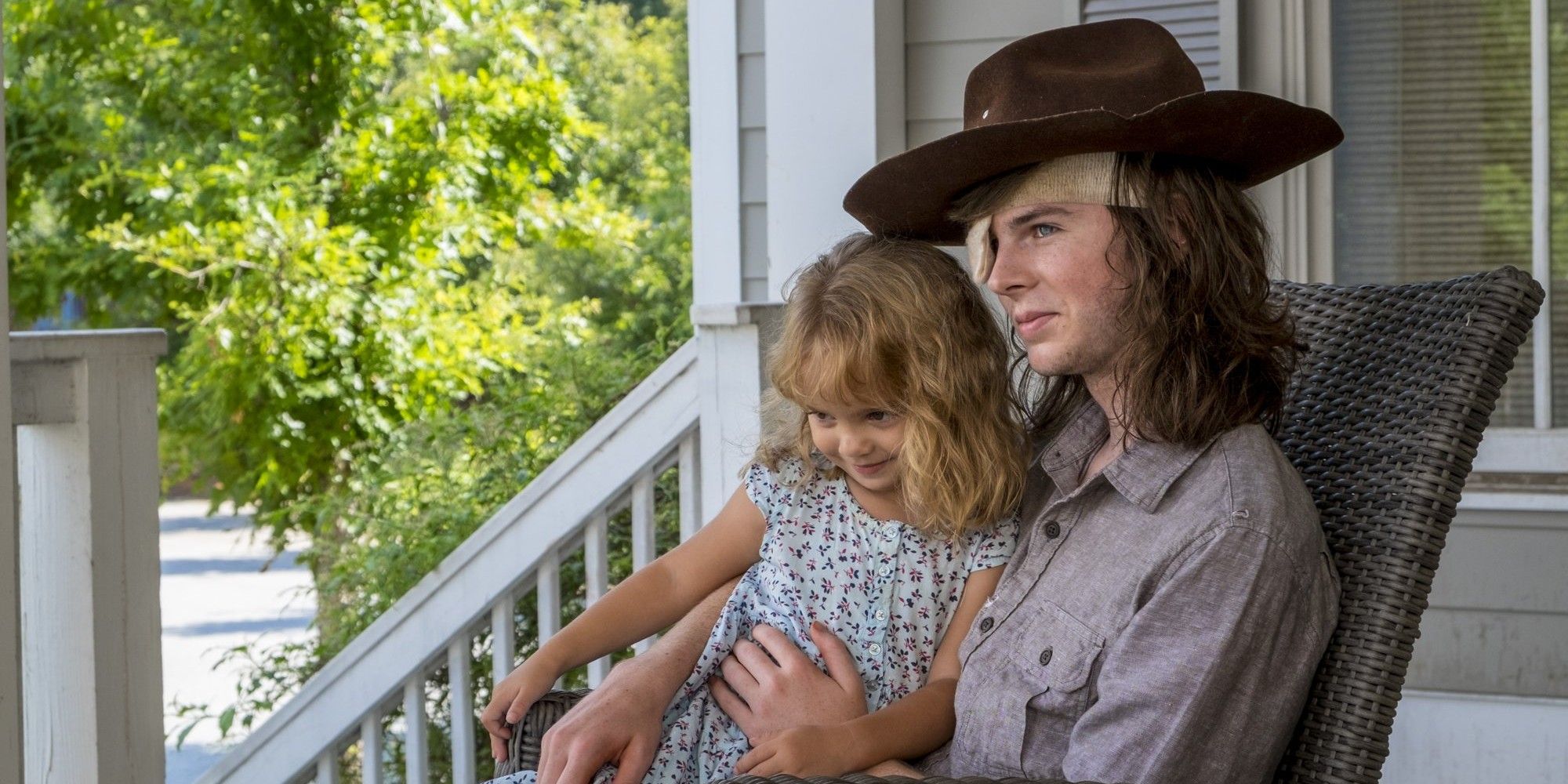 Chandler Riggs as Carl Grimes and Judith in The Walking Dead