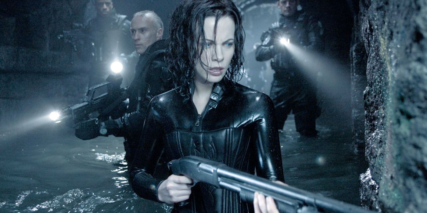 Kate Beckinsale's Selene wading in murky water with armed soldiers in Underworld Evolution