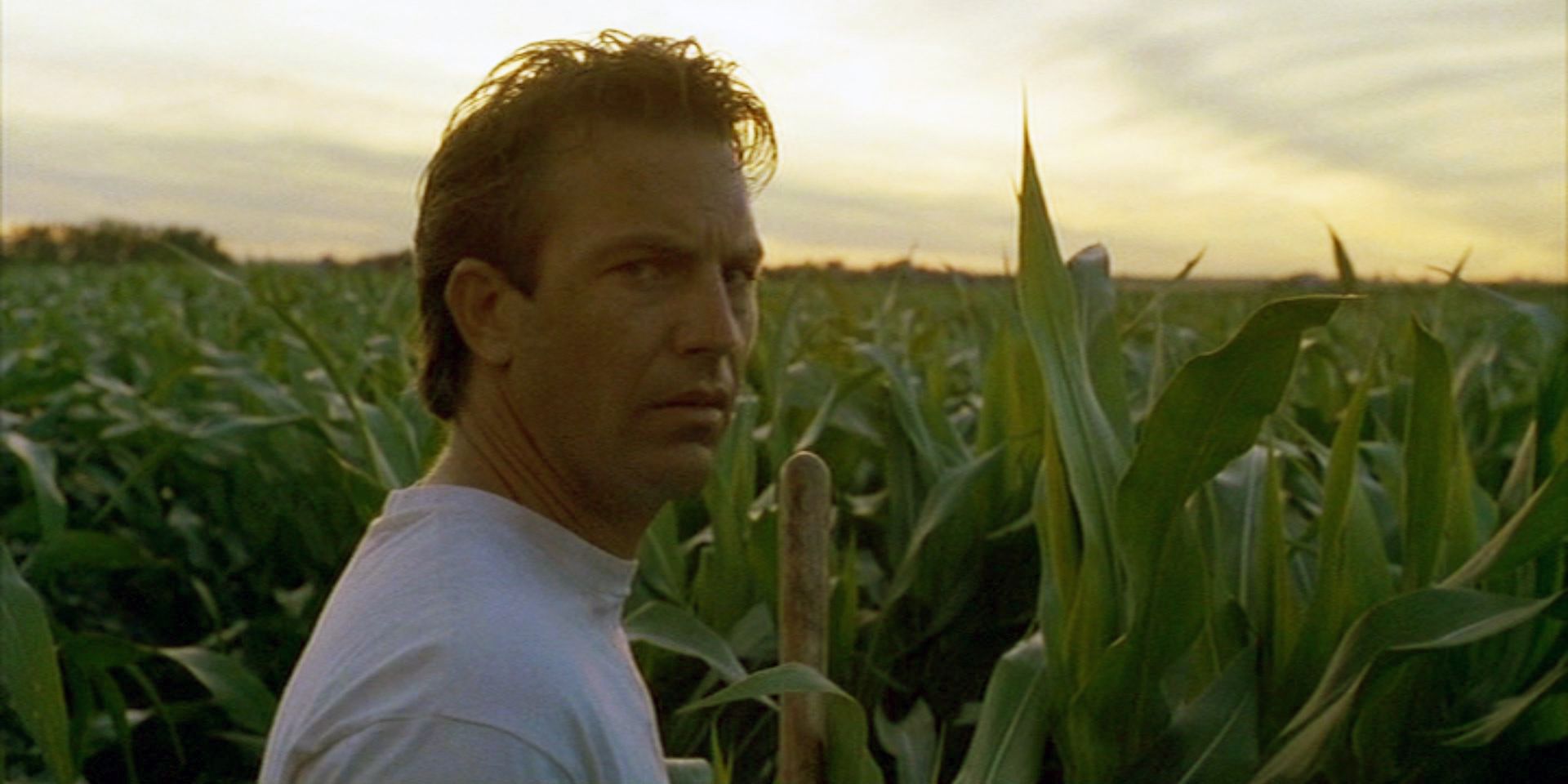Kevin Costner as Ray Kinsella standing in a field in Field of Dreams