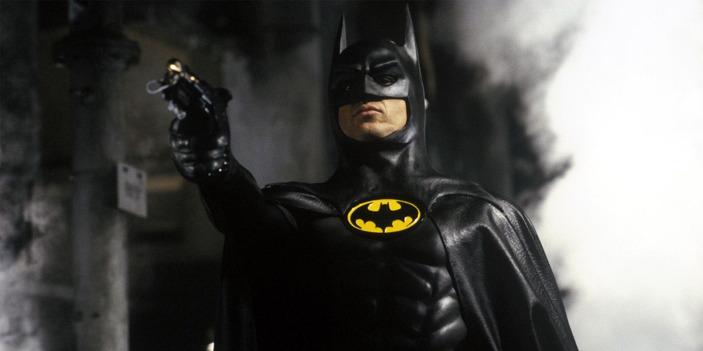 Michael Keaton as Batman holding out a grappling hook