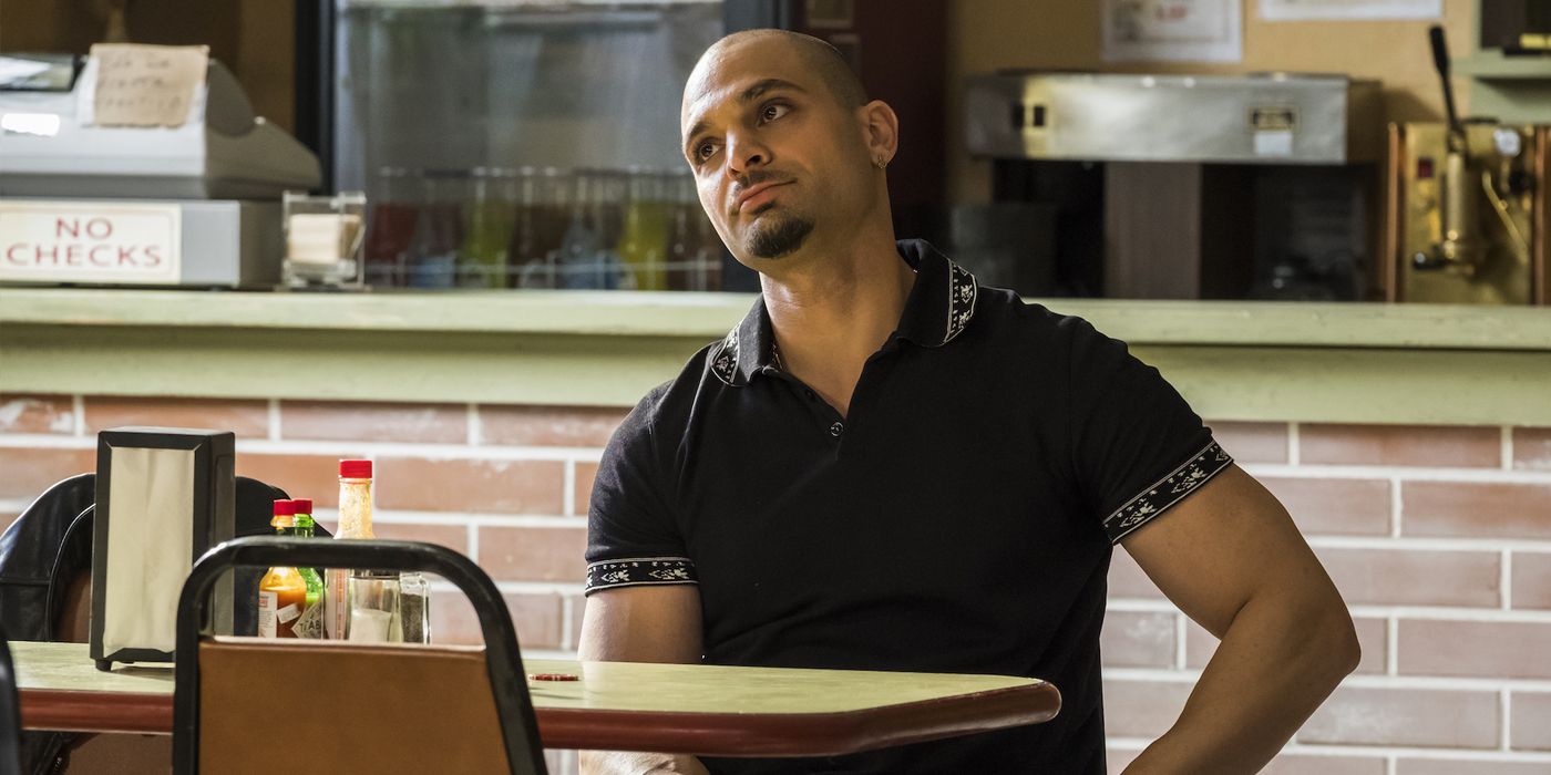 Michael Mando as Nacho in Better Call Saul Season 4 sitting at a table