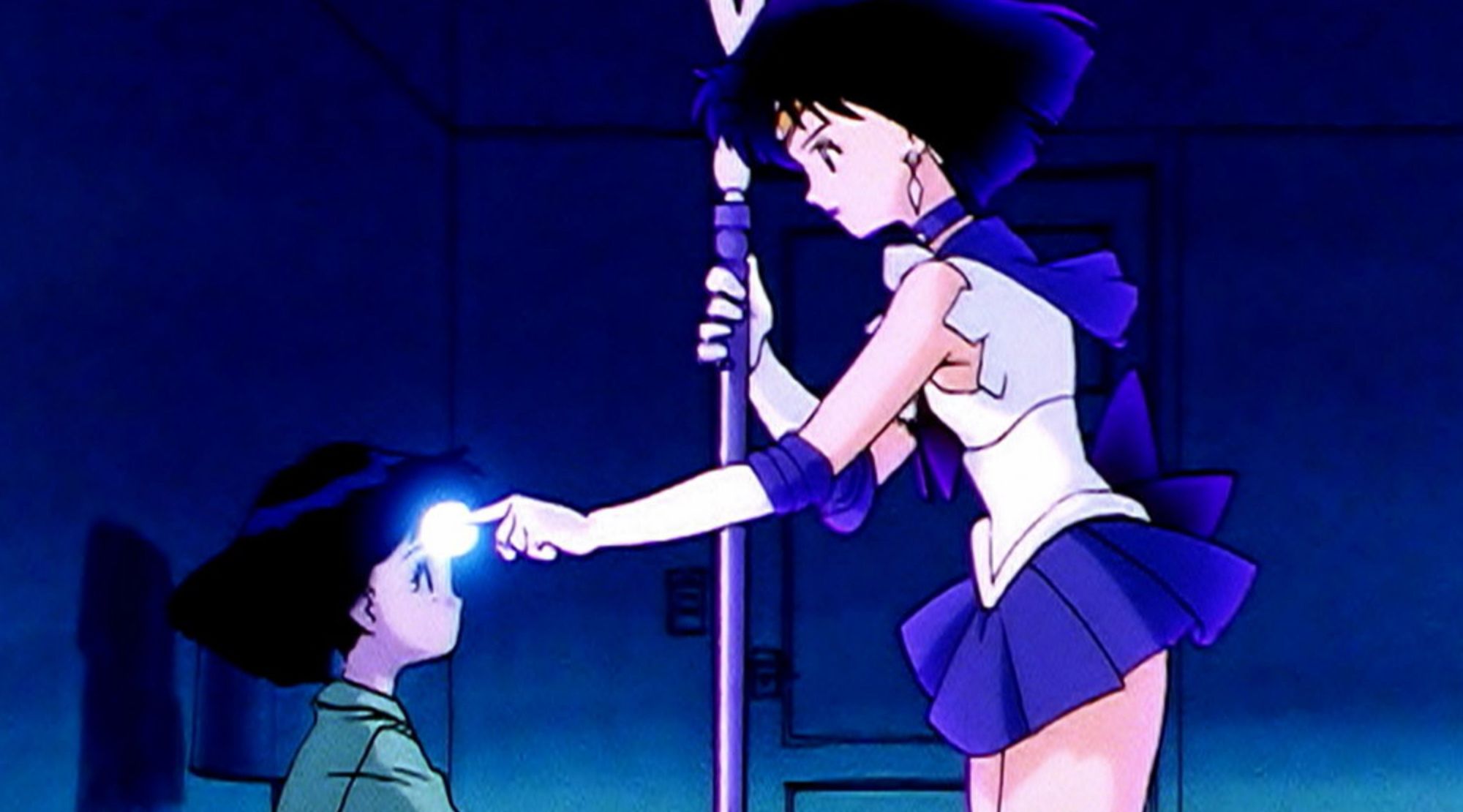 The form of Sailor Saturn touches Hotaru's forehead to awaken her memories in the 90s Sailor Moon anime
