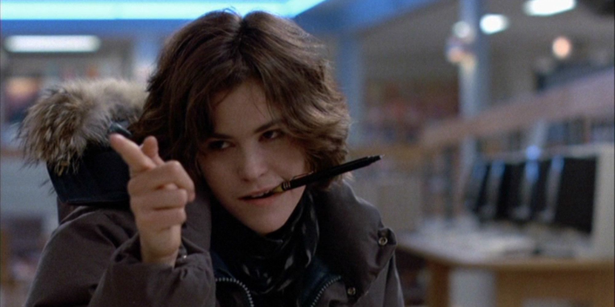 Ally Sheedy chews on a pen and points in The Breakfast Club.