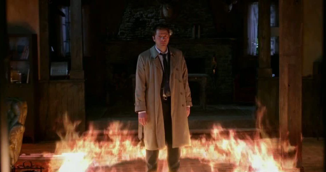 Castiel stands in a ring of fire in Supernatural