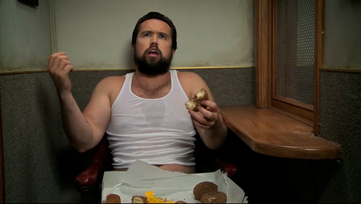 Mac eating donuts in confessional booth