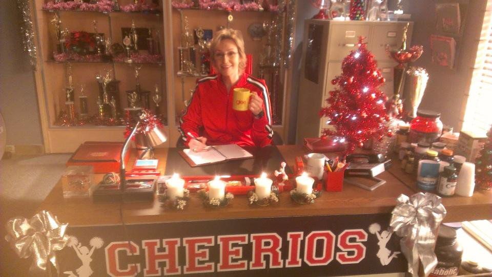 Sue sat at her desk at Christmas in Glee