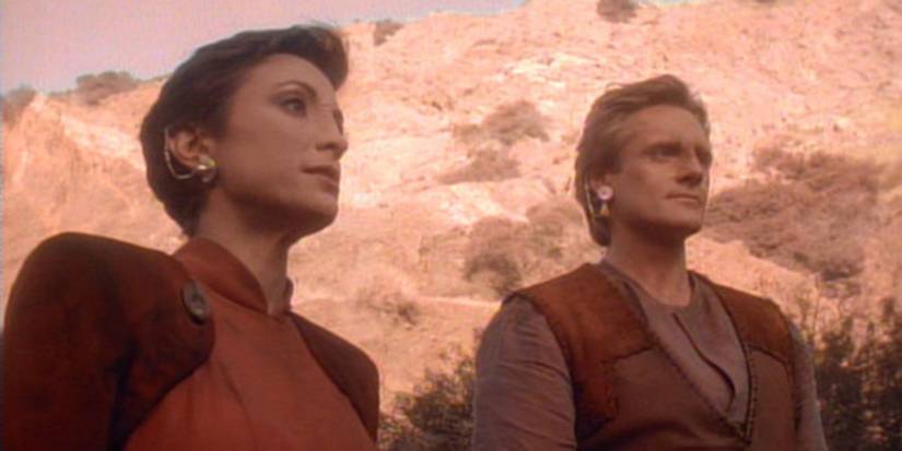 Kira and Shakaar from Star Trek: Deep Space Nine stare off-camera on a desert planet.