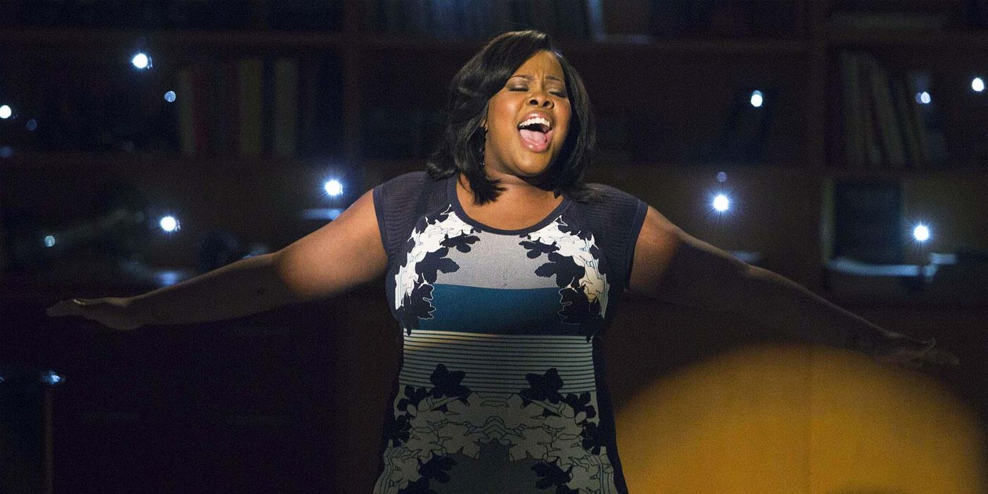 Mercedes belts out a song on stage in Glee