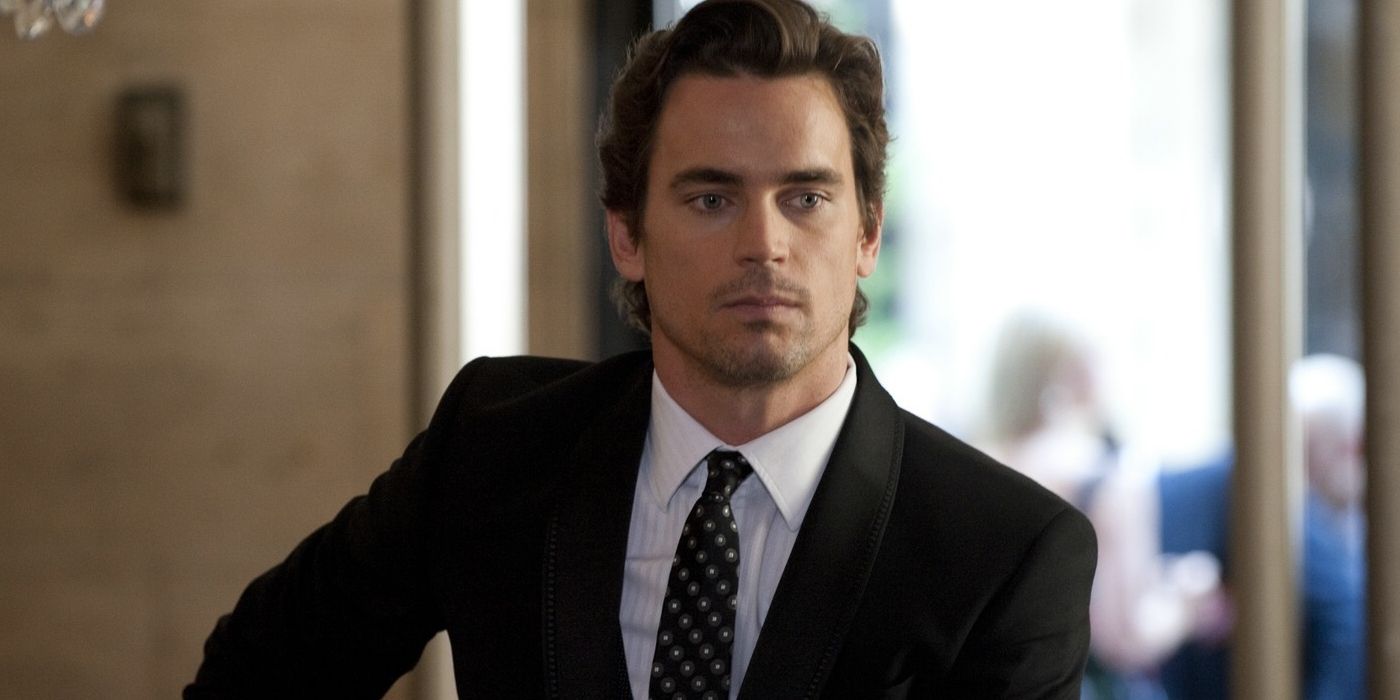 Matt Bomer as Neal Caffrey standing with a serious look on his face in White Collar
