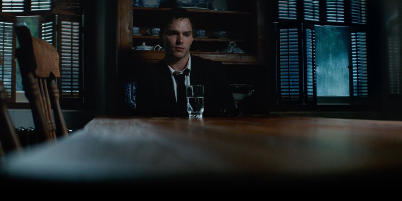 Nicholas Hoult as Hank McCoy sitting at table in X-Men Dark Phoenix