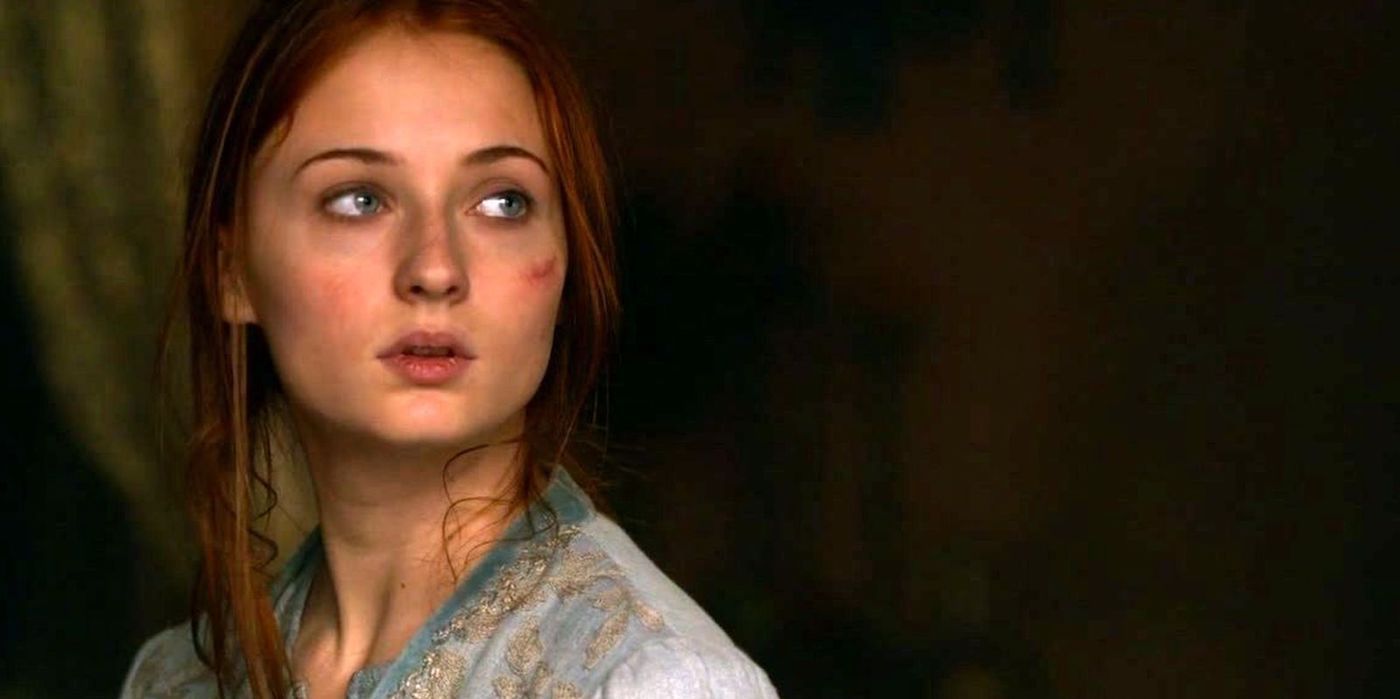 Sansa Stark looking to her left with a scared expression in Game of Thrones.