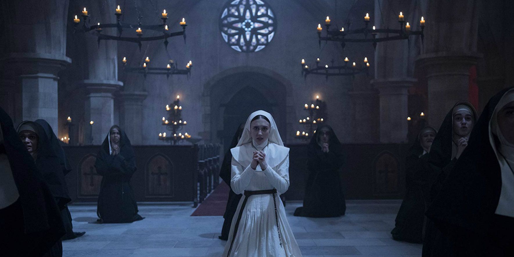 Taissa Farmiga as Sister Irene praying in The Nun