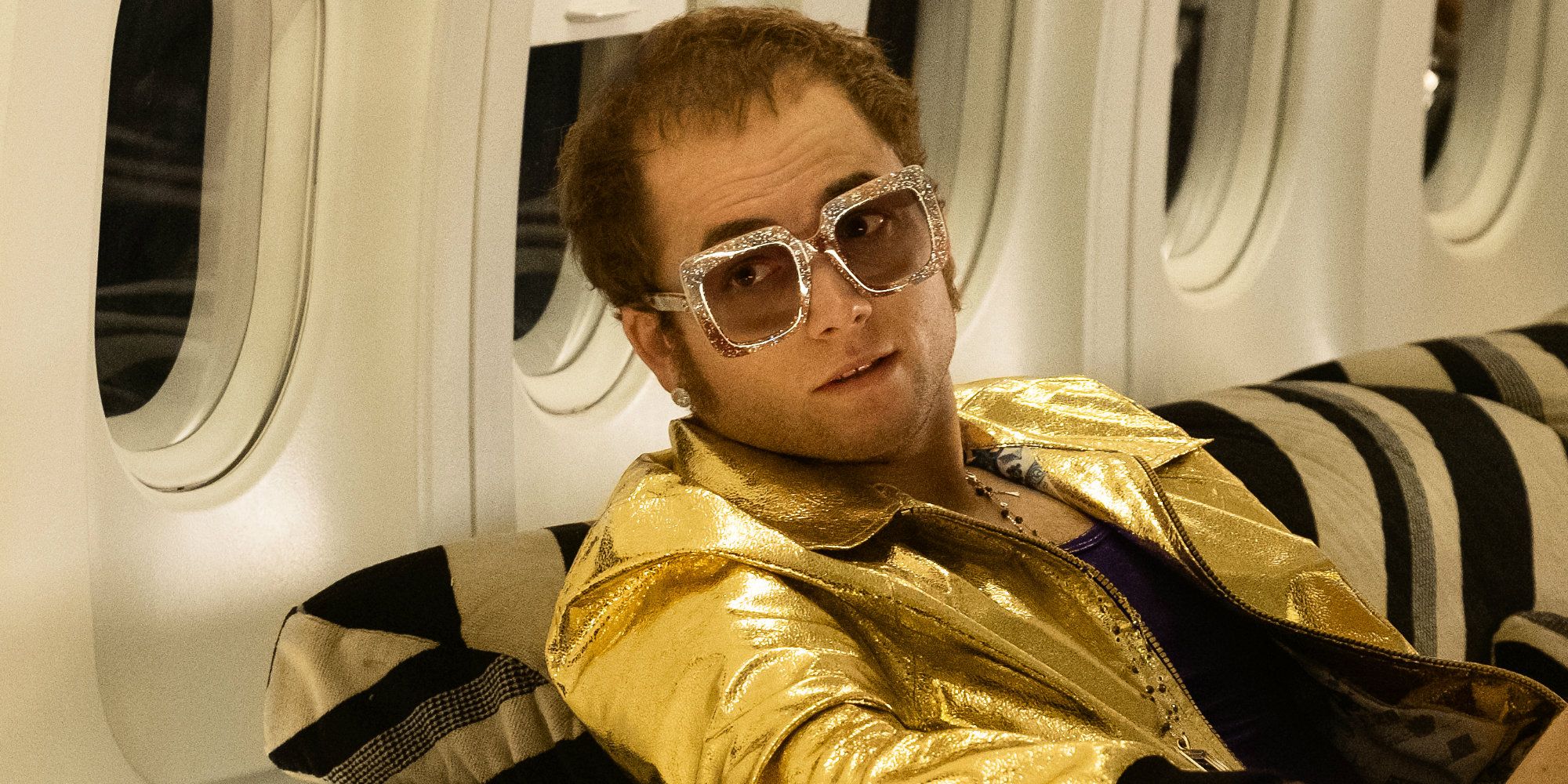 Elton John (Taron Egerton) in his private jet in Rocketman.