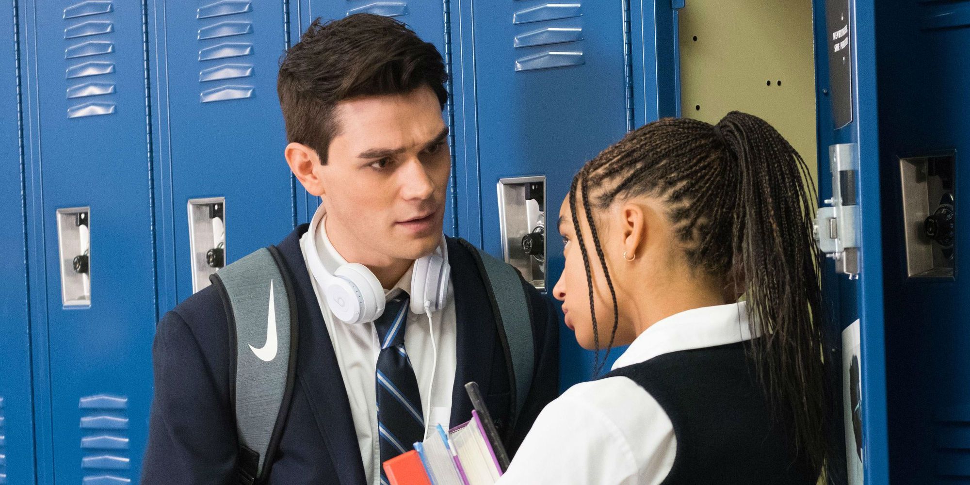 KJ Apa and Amandla Stenberg talking in the school hallway in The Hate U Give KJ 