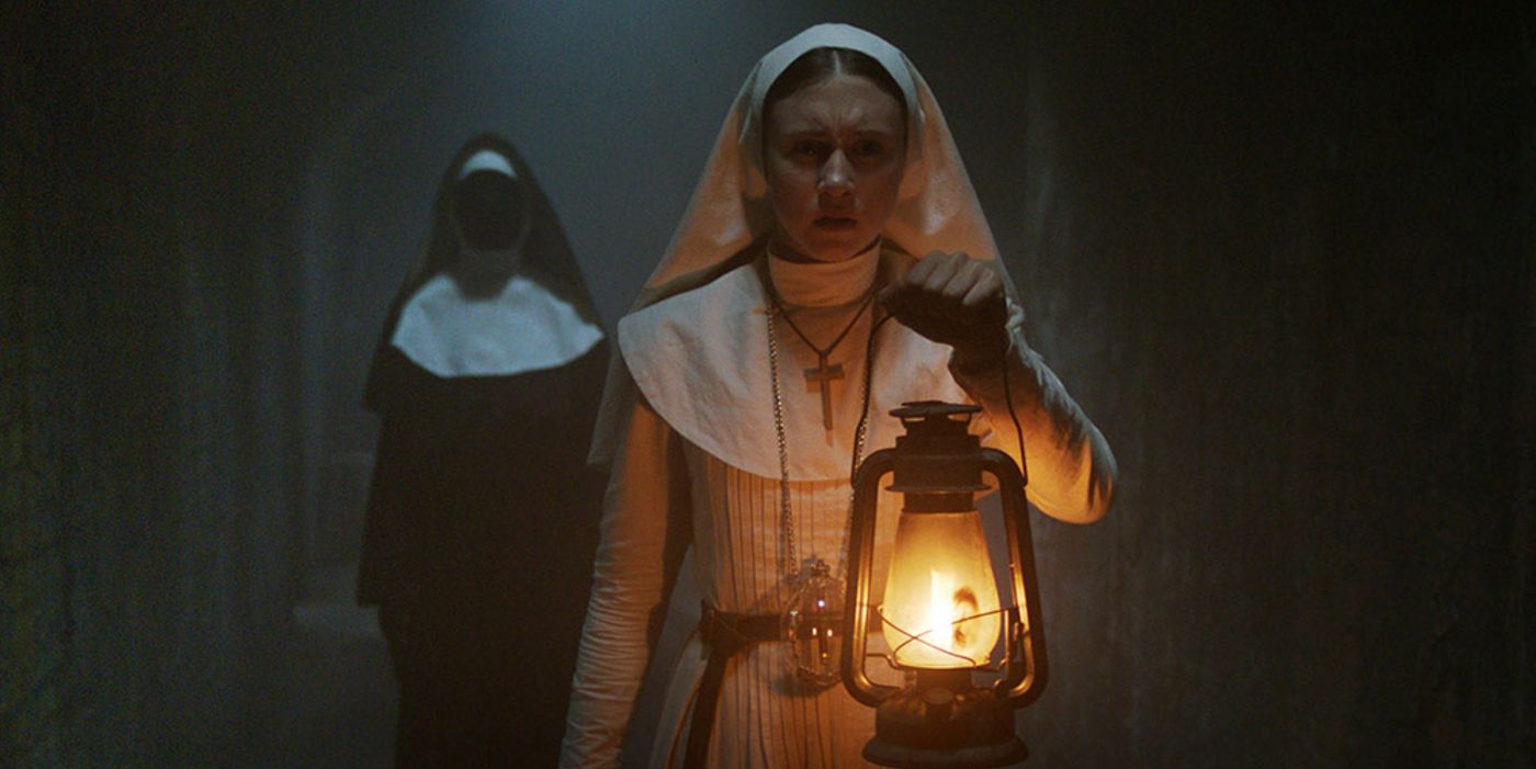 Sister Irene walks with a lantern while there's a nun behind her in The Nun