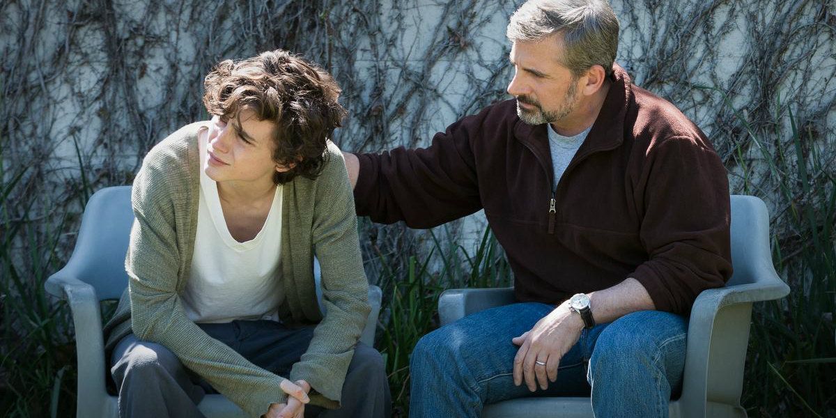 Timothée Chalamet and Steve Carell sit outside in Beautiful Boy