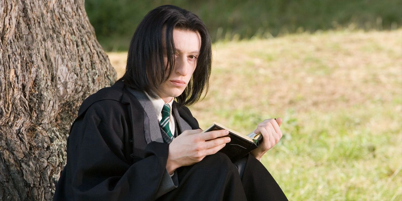 A young Snape sitting under a tree.