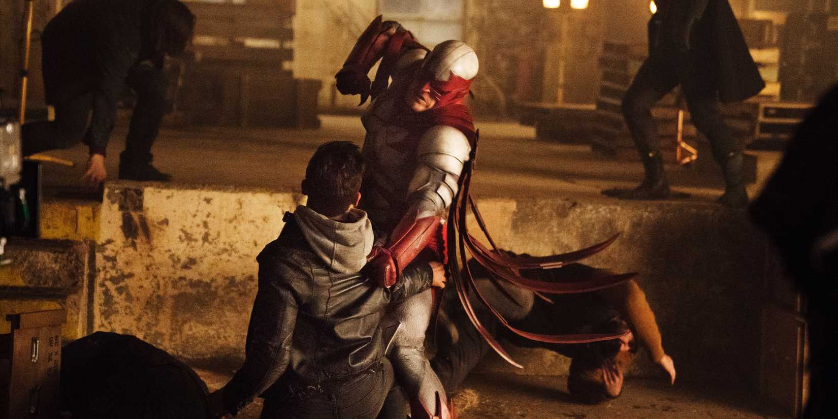 Alan Ritchson as Hawk punching a villain in Titans