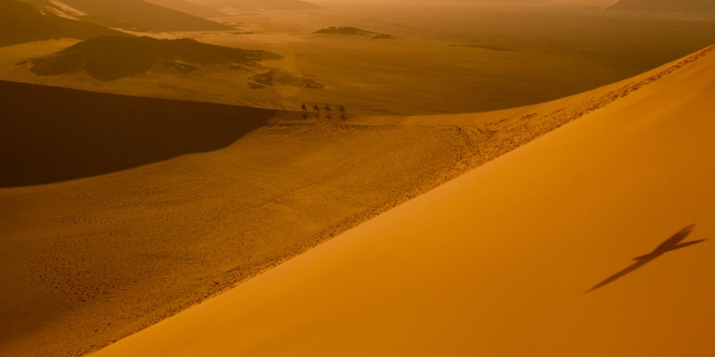 Desert travelers with Iago silhouette in Aladdin teaser trailer
