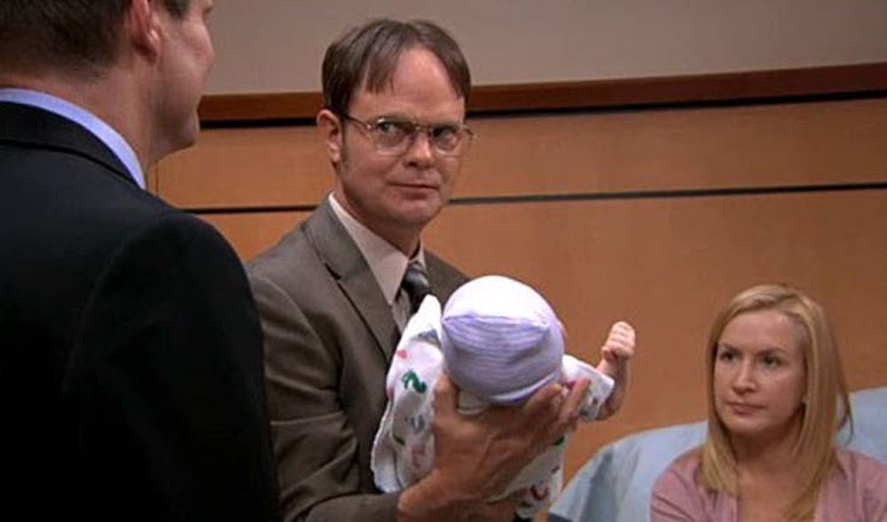 Dwight holding a baby in The Office