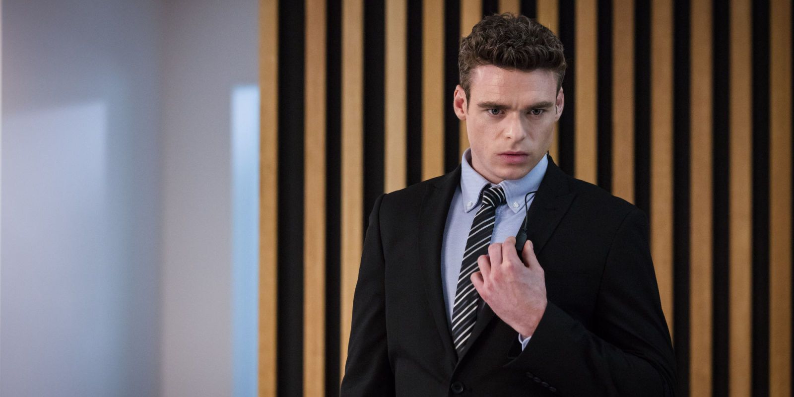 Richard Madden wearing a suit in Bodyguard