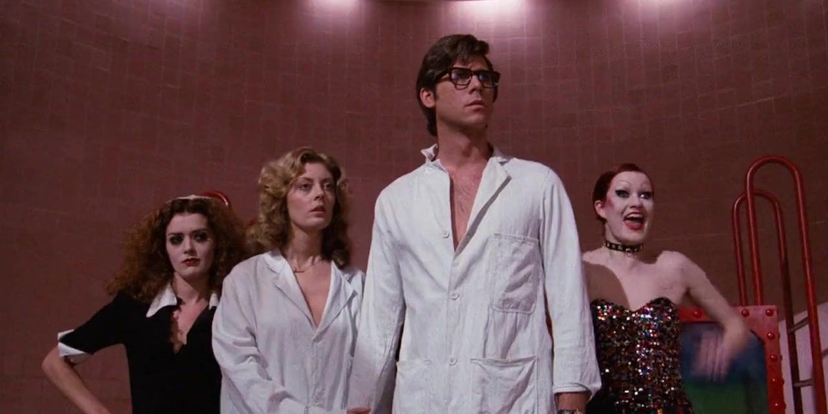 Susan Sarandon in a white shirt standing next to Barry Bostwick and Patricia Quinn in The Rocky Horror Picture Show